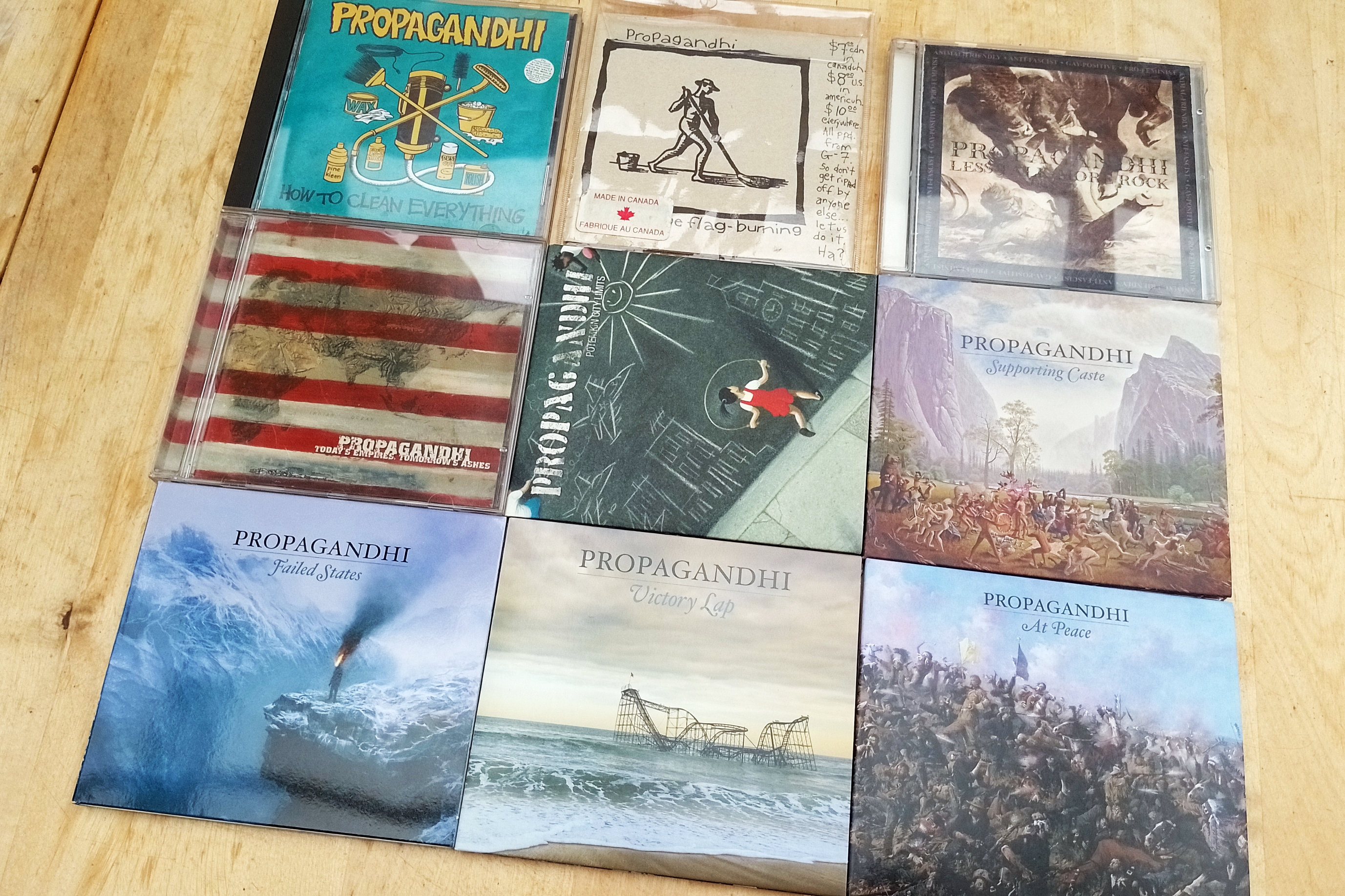 9 CDs by Propagandhi laid out in a 3x3 grid